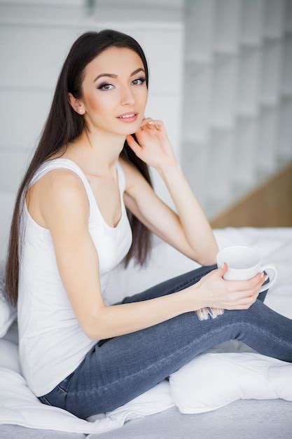 Premium Photo Relaxing On Bed During Weekend Beautiful Woman Relaxing On A Bed And Looking Happy