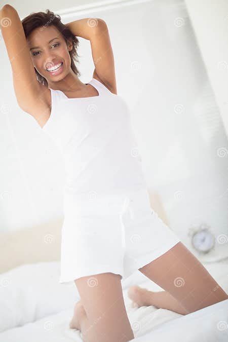 Smiling Brunette Kneeling On Her Bed Posing Stock Image Image Of