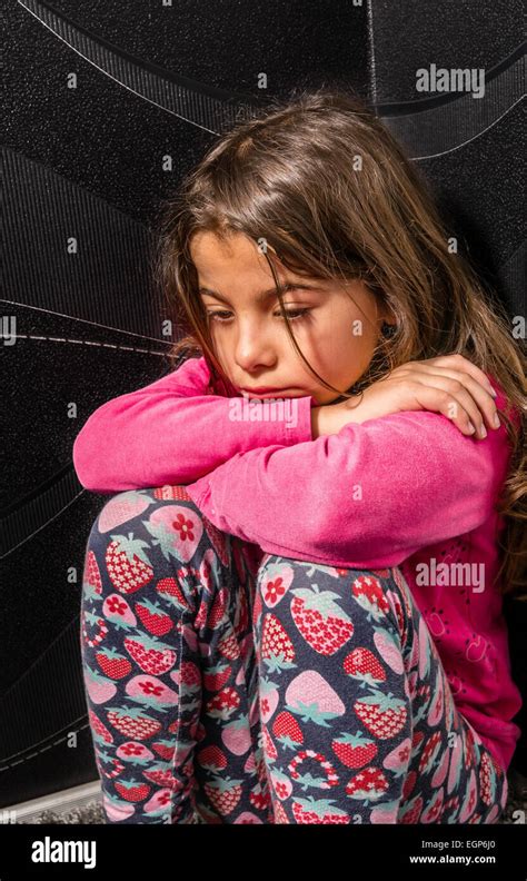 Sad Little Girl Is Sitting In The Corner Of The Room Stock Photo Alamy