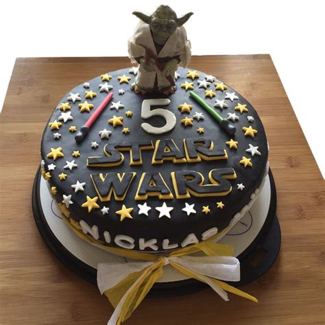A Star Wars Themed Cake On A Wooden Table