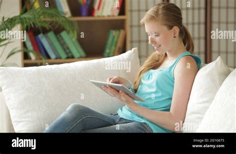 Charming Girl Sitting On Sofa Using Touchpad Looking At Camera And Smiling Stock Video Footage