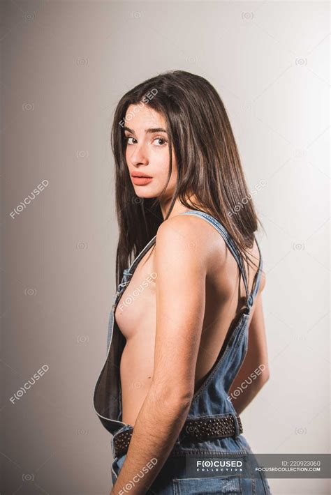 Sexy Girl In Denim Jumpsuit Over Naked Body Posing On Grey Background Perfection Seductive