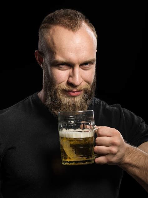 Bearded Man Drinking Beer From A Beer Mug Over Black Background Stock