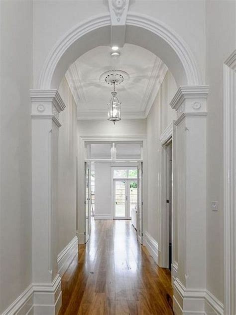An Empty Hallway With White Walls And Wood Floors