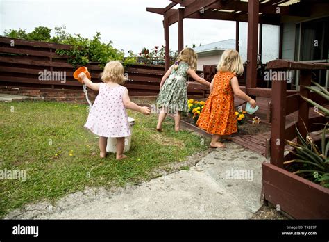 Three Gorgeous Pre School Girls Playing In The Garden At Their Nanas
