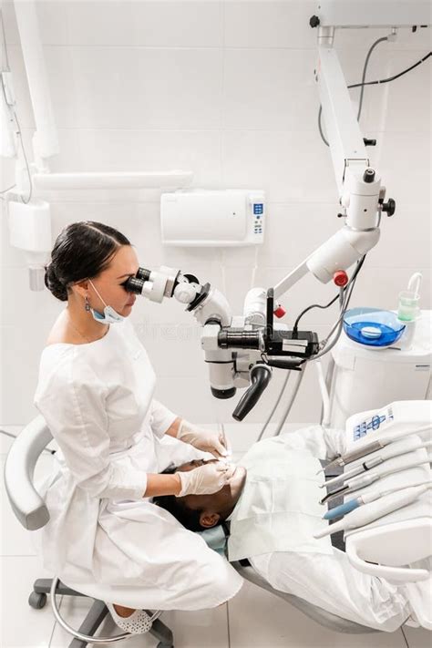 Modern Equipment Microscope In Dental Office Young Woman Dentist