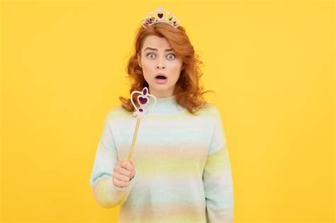 Premium Photo Surprised Redhead Woman In Queen Crown With Magic Wand
