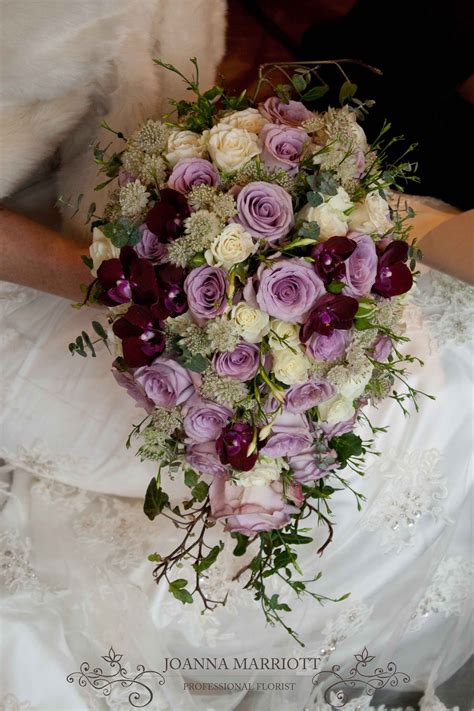 Spoil that special someone with an extra large bouquet of beautiful flowers. Lilac roses, cream spray roses and maroon orchids ...