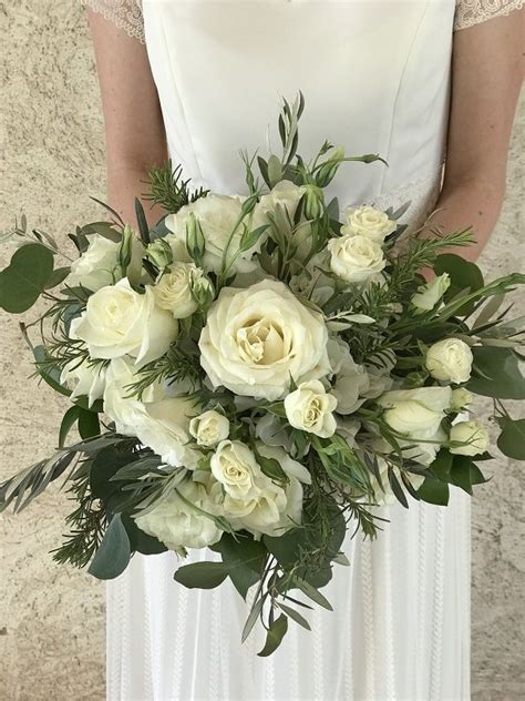 white wedding bouquet with roses lisianthus rosemary olive leaf and silver eucalyptus