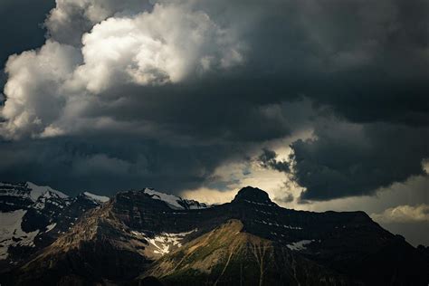 Storm Clouds Over Snowy Mountains In Banff National Park Photograph By