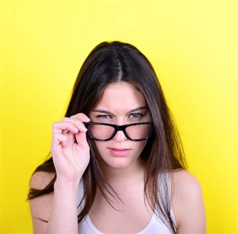 Portrait Of Strict Young Woman Against Yellow Background Stock Image
