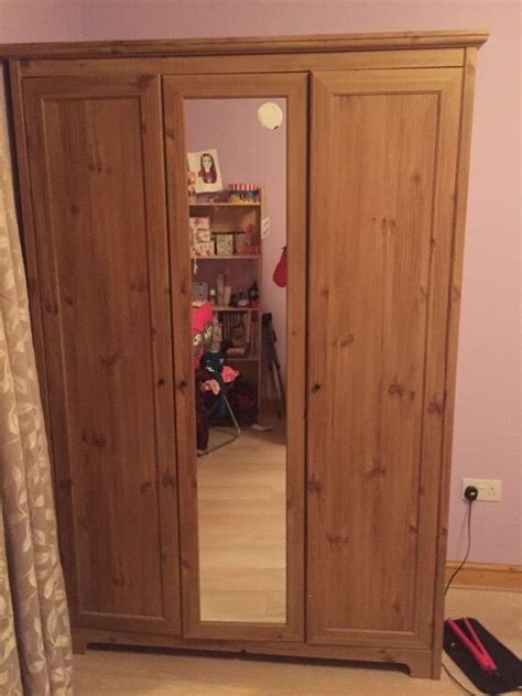 Overview of 3 door wooden wardrobe with drawer. Ikea aspelund 3-door wardrobe and mirror in the middle ...