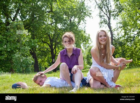 Teenagers Playing In Grass In Park Stock Photo Alamy