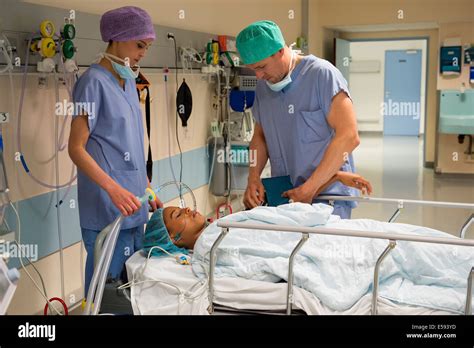 Doctor And Nurse Attending A Patient In Recovery Room Stock Photo Alamy