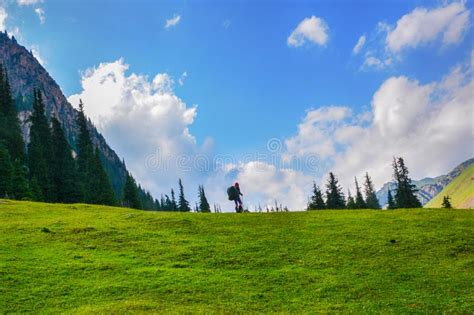 Idyllic Summer Landscape With Hiker In The Mountains With Beautiful