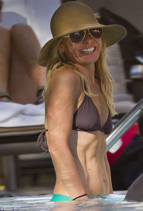 Kelly Ripa gives a cheeky flash of her pert derrière as she hits the beach in Hawaii Daily