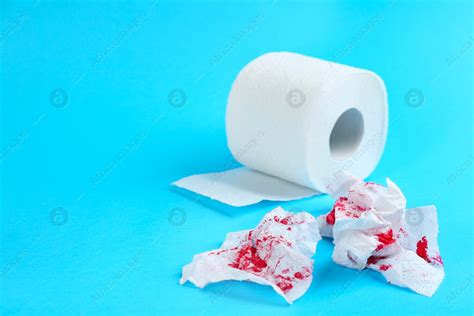 Sheets Of Toilet Paper With Blood On Light Blue Background Space For