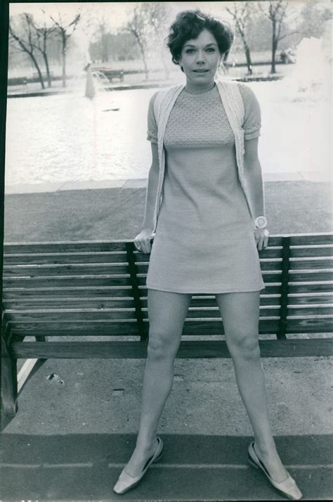 An Old Photo Of A Woman Posing On A Bench