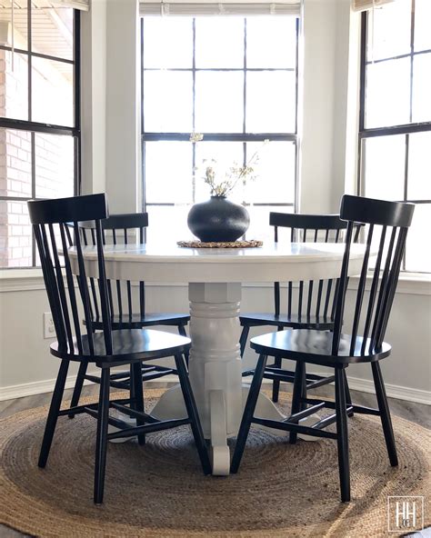 Elegant Round Pedestal Table With Stylish Black Chairs