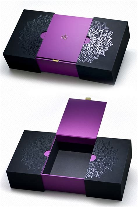 Two Black Boxes With Purple Designs On The Sides And One Has An Open