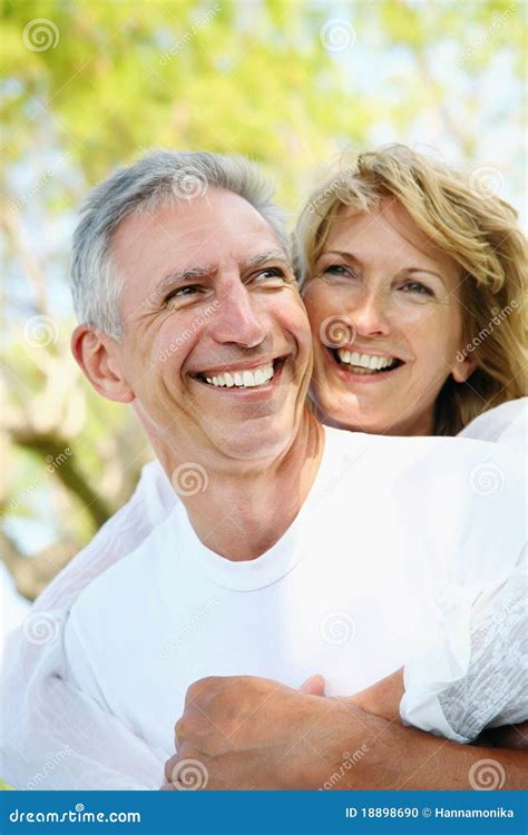 Mature Couple Smiling And Embracing Stock Photo Image Of Active