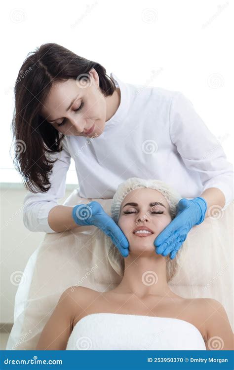 Young Woman Getting Facial Massage And Treatment In Medical Spa Center Or Skin Rejuvenation