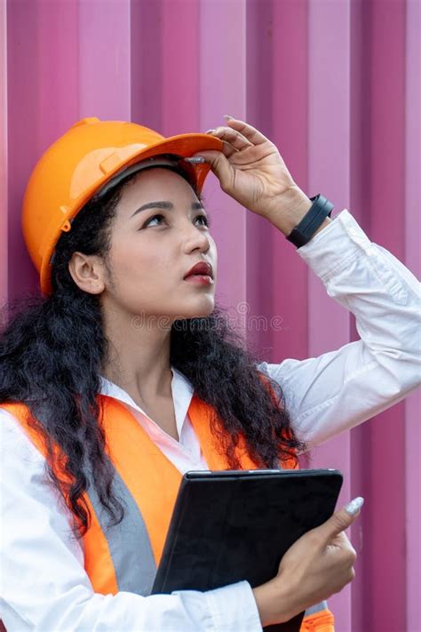 portrait of female worker in cargo containers in shipping container yard woman holding walkie