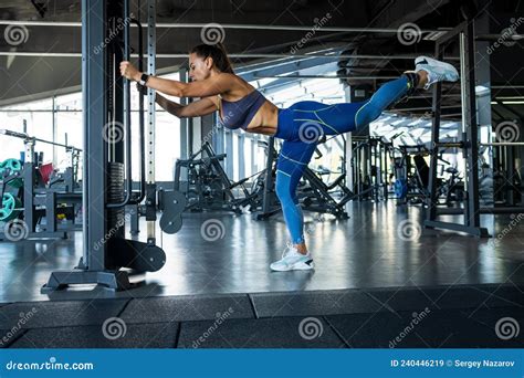 Young Woman Making One Leg Kickbacks In Cable Crossover At Gym Stock Image Image Of Glutes