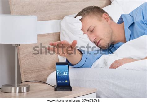 Man Lying On Bed Snoozing Alarm Stock Photo 379678768 Shutterstock