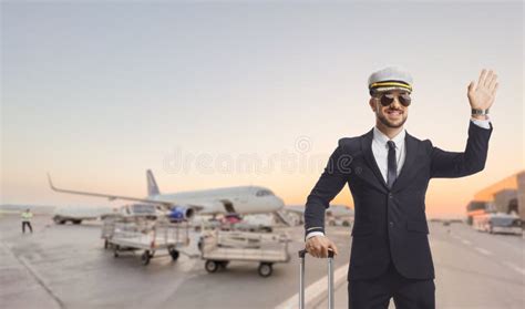 Pilot With A Suitcase Waving From An Airport Apron Stock Photo Image