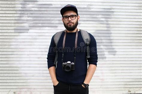 Street Portrait Of A Male Photographer With A Beard In Glasses And A