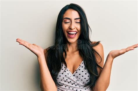 Beautiful Hispanic Woman Wearing Casual Clothes Celebrating Mad And Crazy For Success With Arms