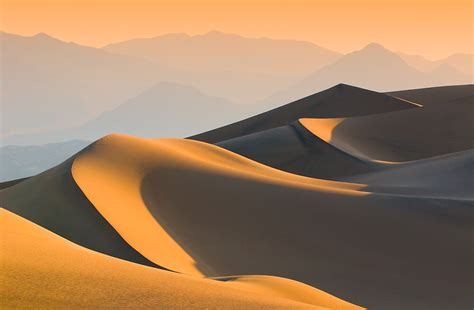 Sand Dunes Over Sunrise Sky In Death Valley California By Javarman