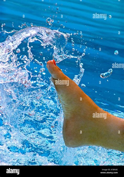 Woman S Foot Splashing The Fresh Clear Water In A Sunny Swimming Pool Stock Photo Alamy