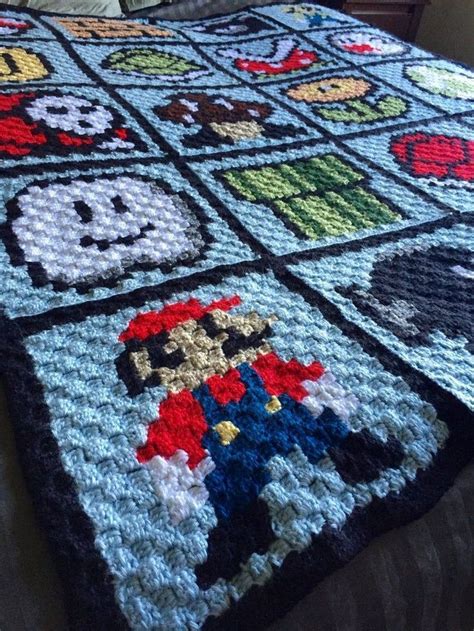 A Crocheted Blanket With Mario And Other Nintendo Characters On It