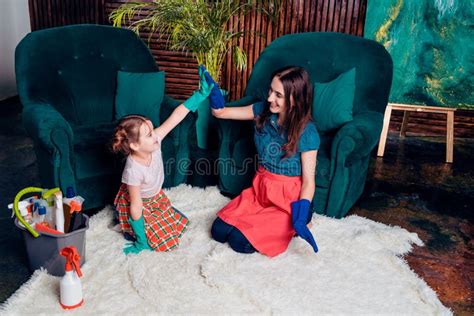 Mom And Daughter In Rubber Gloves Hug Sitting On The Floor After Cleaning Stock Image Image Of