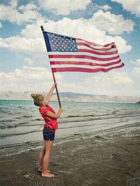 Girl Holding American Flag At Beach Stock Photo Dissolve