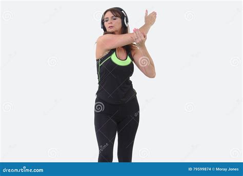 Attractive Middle Aged Woman In Sports Gear Wearing Headphones And