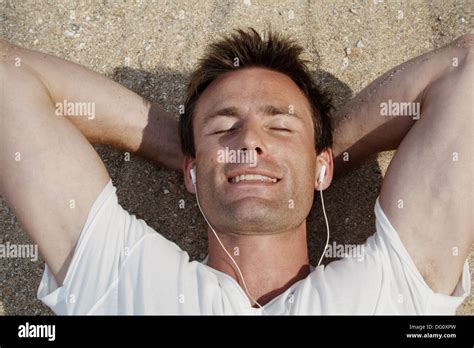 Horizontal Shot Of A God Looking Man Lying On The Beach In India And