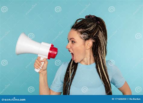 Angry Woman Screaming To The Loudspeaker Isolated Over The Blue