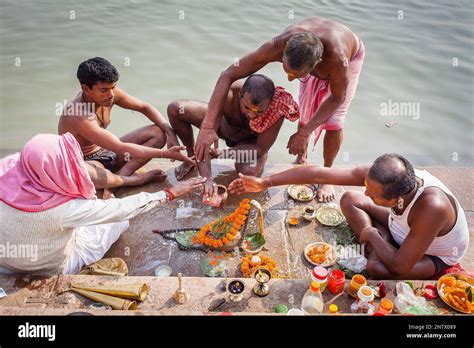 pilgrims making a ritual offering and praying ghats of ganges river varanasi uttar pradesh