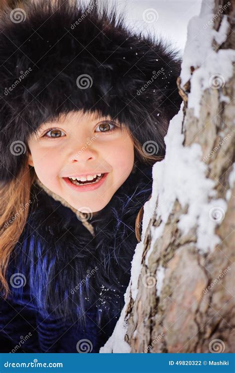 Winter Portrait Of Cute Smiling Child Girl On The Walk In Sunny Snowy