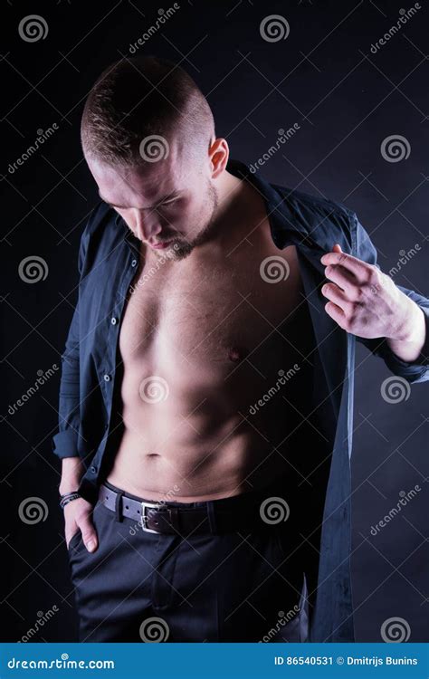 Attractive Confident Young Man With Open Shirt On Muscular Torso