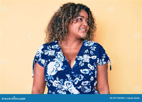 Young African American Plus Size Woman Wearing Casual Clothes Looking
