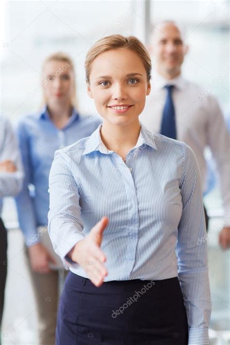 Smiling Businesswoman Making Handshake In Office — Stock Photo © Syda