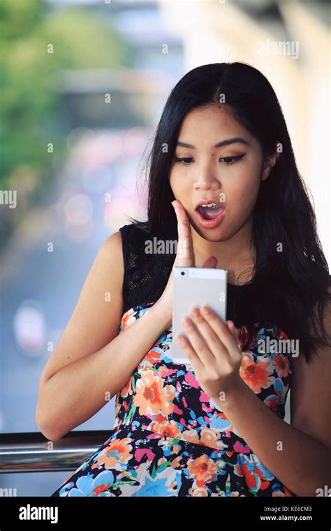 Young Woman Shocked At Text Message On Her Mobile Phone Stock Photo Alamy