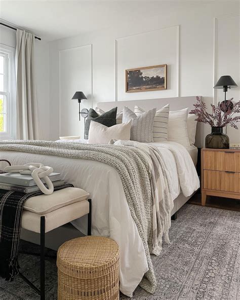 This Bedroom Features White Paneled Walls And A Grey Area Rug A Group