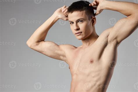 Athlete With Naked Torso Showing Arm Muscles On Gray Background Cropped View Of Bodybuilder