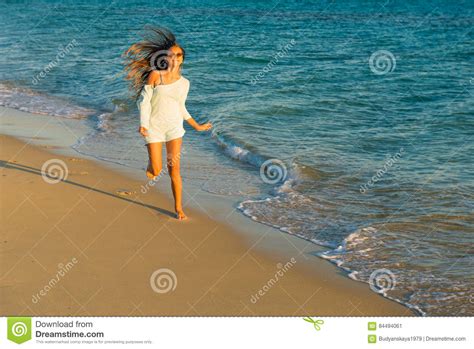 girl runs along the seashore stock image image of sunsetn season 84494061
