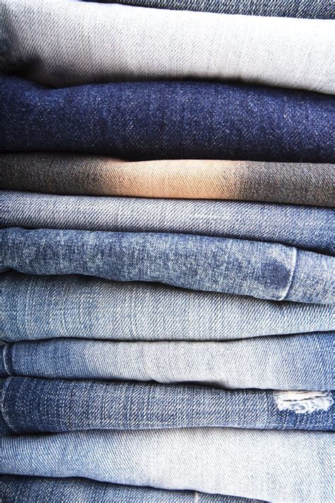 Stack Of Folded Clothes Blue Jeans Pants Dark Blue Denim Trousers On